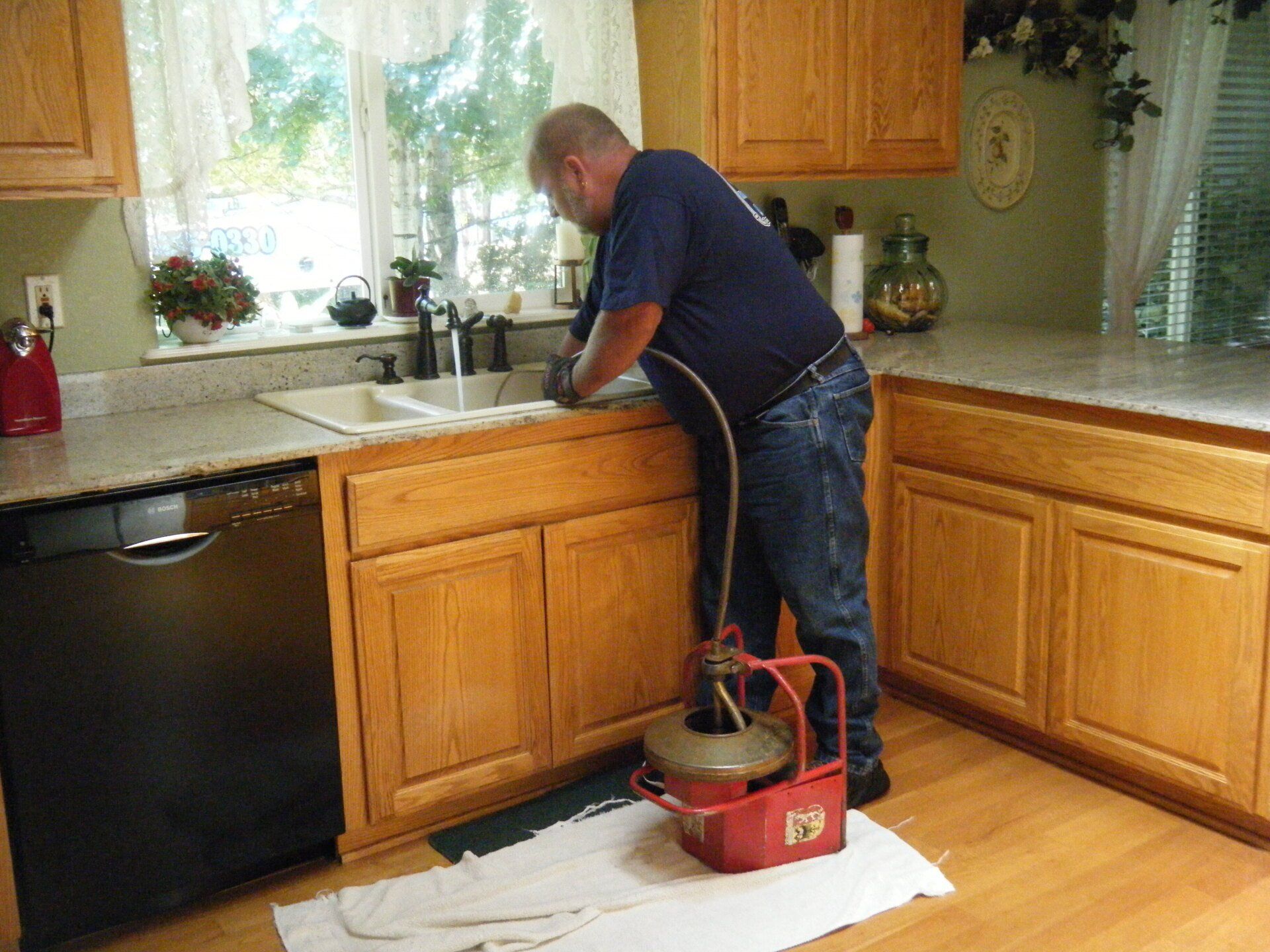 Plumber working under a sink