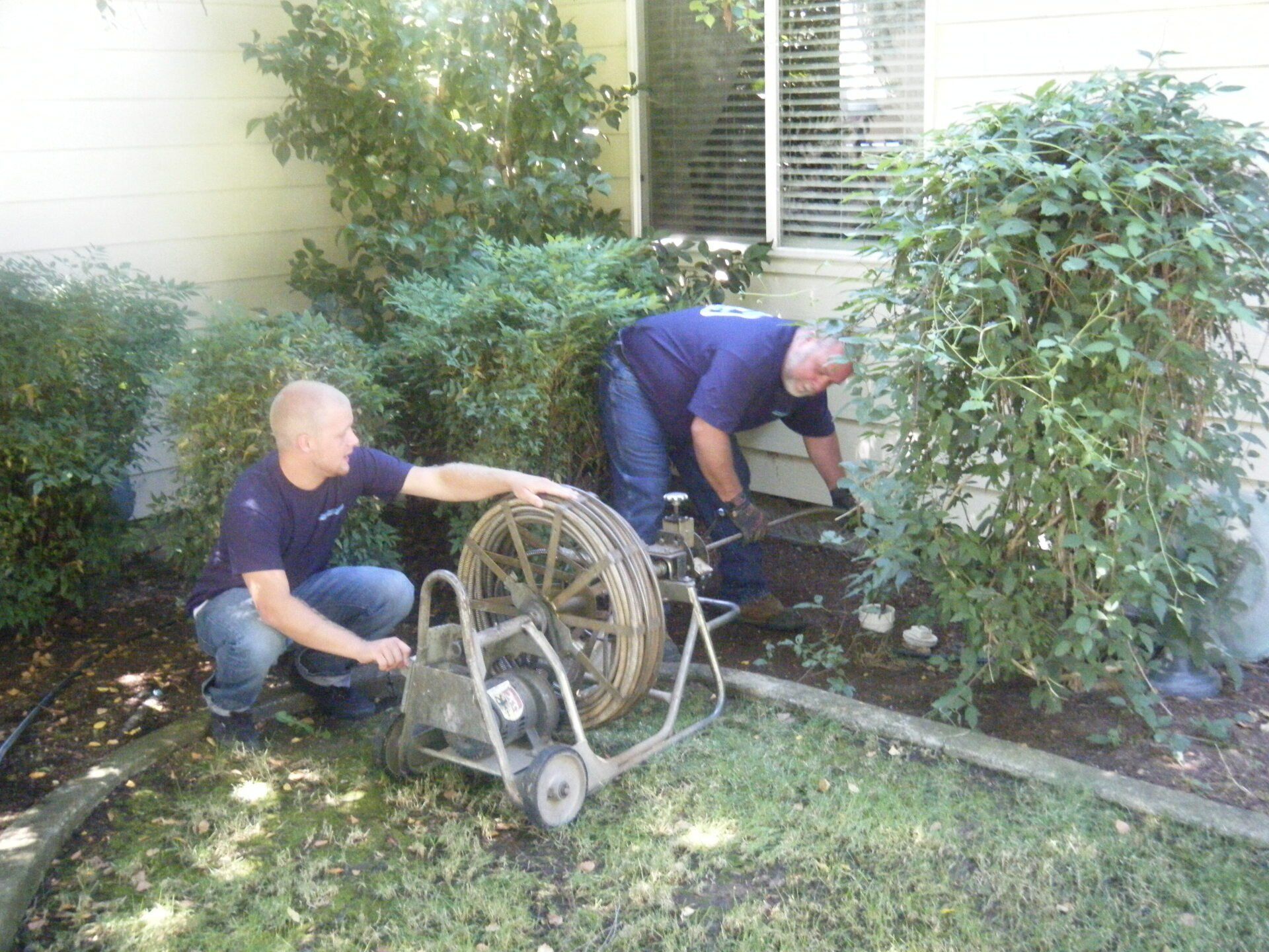 Technicians with drain equipment